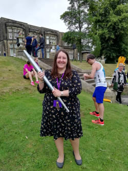 Heather Millard curator at Cliffe Castle Museum holding the 2018 Pyeongchang torch at the Incredible Me celebration day