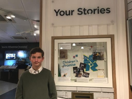 Daniel Bleasdale next to his 2012 Childrens Promise display in the Paralympic Heritage Centre