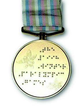 Reverse side of the gold medal with braille from the Nagano 1998 Paralympic Games