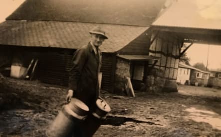 George Evered with milk pails collected for Nestle factory