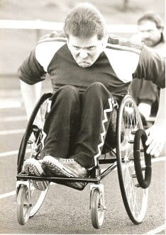 Paul Cartwright competing in wheelchair racing on the athletics track