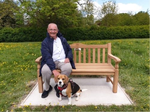 NPHT Volunteer, Shaun Finegan, sat on a bench dedicated to his wife.