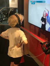 Child watching and listening using headphones Paralympic heritage films