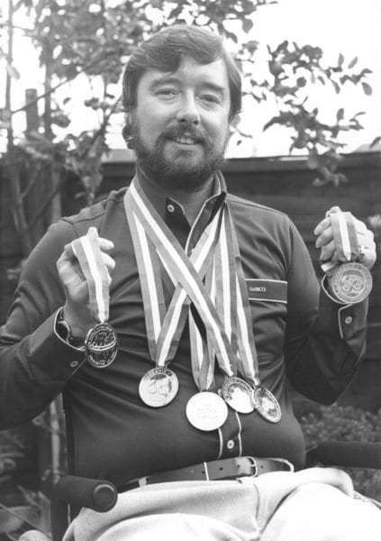 Paralympic swimmer Mike Kenney with his medals.