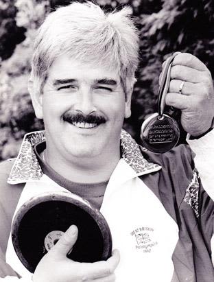 Black and white photo of Kevan Baker with his medals.